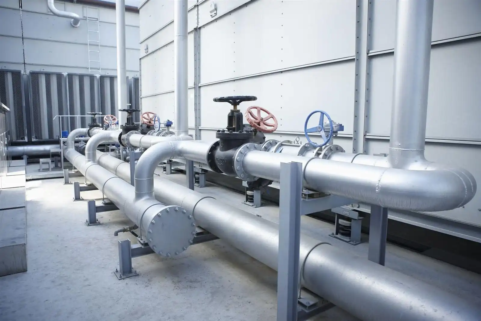 Industrial gate valves with manual handwheels installed in a stainless steel process piping system.